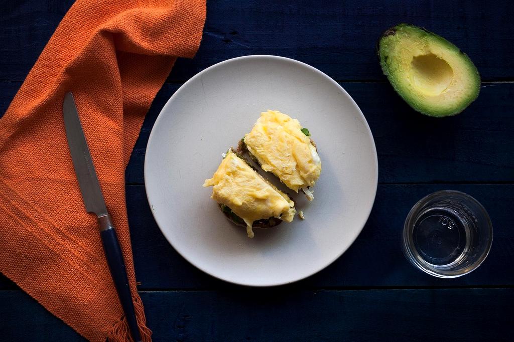 Green avocado on wooden table